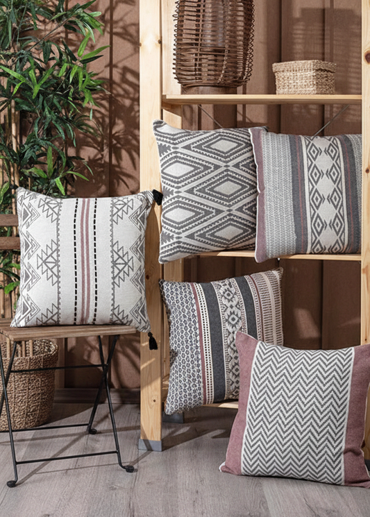 Decorative pillows with geometric patterns on a wooden shelf
