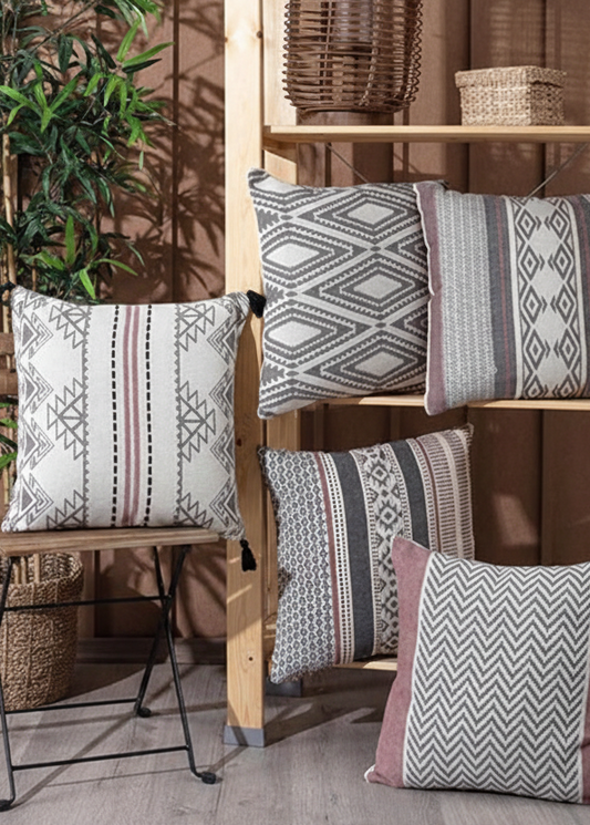 Decorative pillows with geometric patterns on a wooden shelf